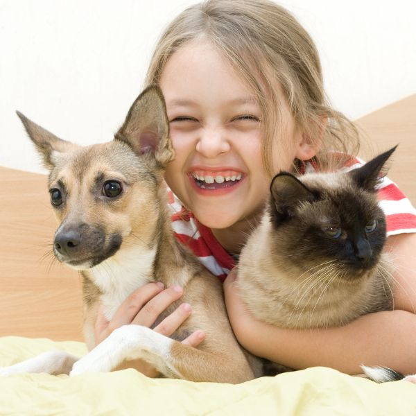 Girl with her cat and dog loves eco-friendly cleaning.