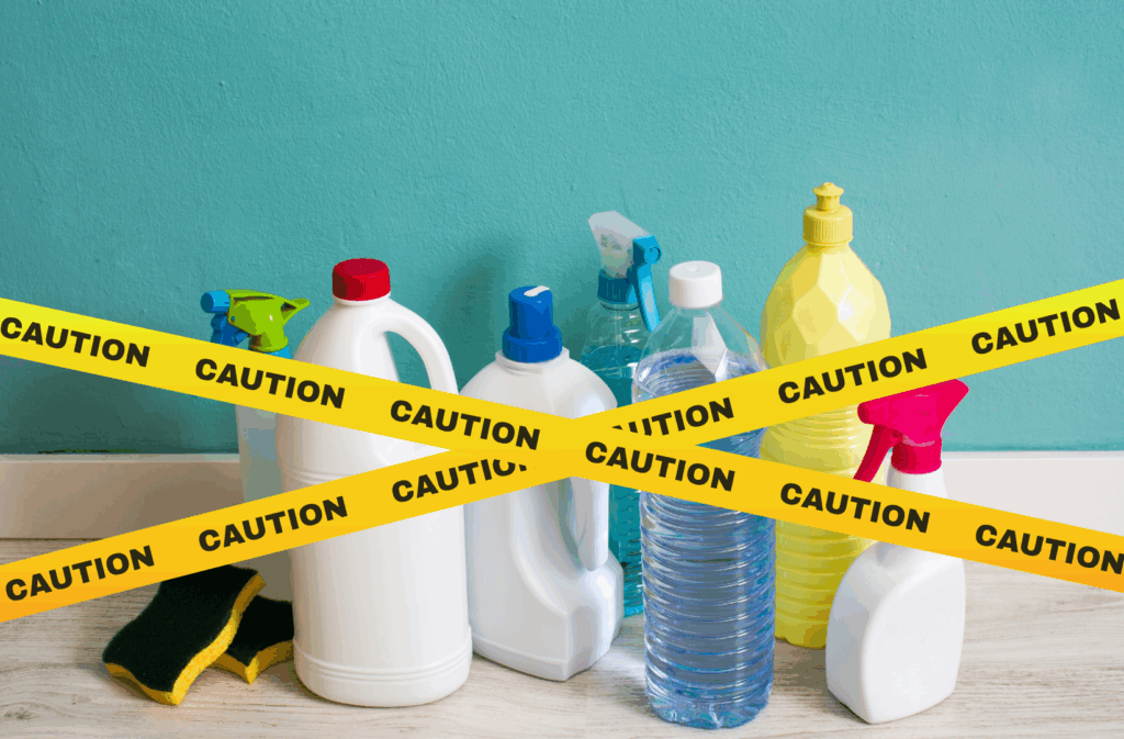 Cleaning products on top of a table with a caution band crossing them.