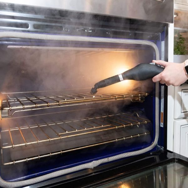 Steam cleaning an oven.