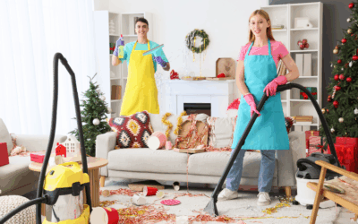 Two professional cleaners tidy a festive living room, vacuuming scattered party decorations and restoring order after a holiday celebration.